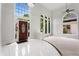 Bright foyer with high ceilings, arched windows, tile flooring, and a view of the front entrance at 710 Glen Royal Dr, Roswell, GA 30076