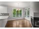 Eat-in kitchen with large windows, fireplace, hardwood floors and a chandelier at 710 Glen Royal Dr, Roswell, GA 30076