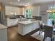 Bright kitchen with white cabinets, modern appliances, and a breakfast nook at 710 Glen Royal Dr, Roswell, GA 30076