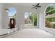 Bright living room with carpet, large arched windows, and ceiling fan offers lots of natural light at 710 Glen Royal Dr, Roswell, GA 30076