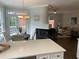 Open floor plan featuring a living room with fireplace connected to a bright eat-in kitchen at 710 Glen Royal Dr, Roswell, GA 30076