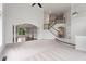 Bright living area features staircase, high ceilings and archway to dining room at 710 Glen Royal Dr, Roswell, GA 30076