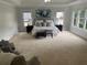 Spacious main bedroom featuring soft carpet, neutral walls, and ample natural light at 710 Glen Royal Dr, Roswell, GA 30076