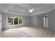 Large bedroom with a ceiling fan, carpet, and windows to provide natural light at 710 Glen Royal Dr, Roswell, GA 30076