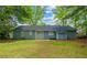 Back exterior view of house showing sliding glass door to fenced backyard with green lawn at 7629 Park Ln, Jonesboro, GA 30236
