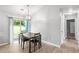 Dining area featuring modern light fixture, a sliding glass door and wood-look flooring at 7629 Park Ln, Jonesboro, GA 30236