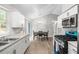 Bright kitchen with granite countertops, stainless steel appliances, white cabinets, and eat-in table at 7629 Park Ln, Jonesboro, GA 30236