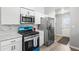 A modern kitchen with stainless steel appliances, granite countertops, and a rear entrance door at 7629 Park Ln, Jonesboro, GA 30236