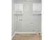 Utility room with washer and dryer hookups and overhead cabinets at 7629 Park Ln, Jonesboro, GA 30236