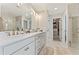 Bright bathroom with double vanity, walk in glass shower and neutral decor at 3672 Silvery Way, Powder Springs, GA 30127