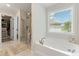 Bright bathroom features a soaking tub, walk in shower and access to a closet at 3672 Silvery Way, Powder Springs, GA 30127
