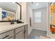 Chic bathroom with gray vanity, sleek fixtures, framed mirror, and a vibrant shower curtain for a modern touch at 3672 Silvery Way, Powder Springs, GA 30127