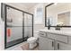 Modern bathroom features a glass enclosed shower, white vanity and toilet at 3672 Silvery Way, Powder Springs, GA 30127