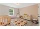Cozy Bedroom with crib, dresser, and accent chair creating a warm, inviting, and playful atmosphere at 3672 Silvery Way, Powder Springs, GA 30127