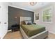 Modern bedroom with decorative grey accent wall, large window, and neutral decor at 3672 Silvery Way, Powder Springs, GA 30127
