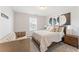 Bright bedroom with a queen bed, chair, and modern decor; neutral color palette for a calming space at 3672 Silvery Way, Powder Springs, GA 30127