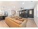 Open living room features a brick fireplace, flat screen tv, and stylish sectional sofa at 3672 Silvery Way, Powder Springs, GA 30127