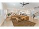 Open floor plan with a dining area and kitchen overlooking the living room with brown sectional sofa at 3672 Silvery Way, Powder Springs, GA 30127