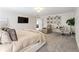 Bright main bedroom features a massage chair, desk, tv and neutral decor at 3672 Silvery Way, Powder Springs, GA 30127