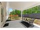Relaxing outdoor patio area with stylish seating overlooking a green lawn and wooded backdrop at 3672 Silvery Way, Powder Springs, GA 30127