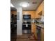 This compact kitchen features stainless steel appliances, granite countertops, and stylish wood cabinets at 381 Ralph Mcgill Ne Blvd # K, Atlanta, GA 30312