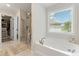 Bathroom with a soaking tub, glass shower, and access to a walk-in closet at , Powder Springs, GA 30127