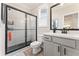 Updated bathroom featuring a modern vanity, framed mirror, and a glass-enclosed shower at , Powder Springs, GA 30127