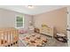 Bright Bedroom features a crib, dresser, and comfy armchair perfect for a growing Gathering at , Powder Springs, GA 30127