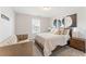Relaxing bedroom with a cozy chair, plush bed, and tasteful abstract art at , Powder Springs, GA 30127