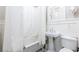 Classic bathroom featuring a clawfoot tub, pedestal sink, and white wainscoting at 1125 Briarcliff Ne Pl # 14, Atlanta, GA 30306