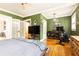 Bedroom with hardwood floors, green walls, crown molding and a workout area with an exercise bike at 1125 Briarcliff Ne Pl # 14, Atlanta, GA 30306