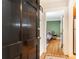A partial view of a cozy bedroom with green walls and hardwood floors as seen from the entry door at 1125 Briarcliff Ne Pl # 14, Atlanta, GA 30306