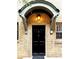Charming brick entryway with a black door featuring unit number and overhead light fixture at 1125 Briarcliff Ne Pl # 14, Atlanta, GA 30306
