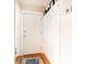 Hallway features white wainscoting, coat hooks, hardwood floors, and a front door for a welcoming entrance at 1125 Briarcliff Ne Pl # 14, Atlanta, GA 30306