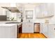 Bright kitchen featuring white cabinetry, stainless steel appliances, and hardwood flooring at 1125 Briarcliff Ne Pl # 14, Atlanta, GA 30306