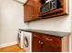 Laundry room featuring stacked washer/dryer, dark granite countertop, and modern wooden cabinets at 1125 Briarcliff Ne Pl # 14, Atlanta, GA 30306