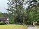 Charming home with a well-maintained lawn, tree coverage, and a long driveway at 1935 Flat Shoals Se Rd, Conyers, GA 30013