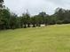 Expansive front yard with lush, well-maintained lawn and mature trees enhancing the property's curb appeal at 1935 Flat Shoals Se Rd, Conyers, GA 30013
