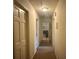 Hallway with neutral color palette and doors leading to various rooms at 1935 Flat Shoals Se Rd, Conyers, GA 30013