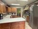 Spacious kitchen with wood cabinets, tile floors, stainless steel appliances, and ample counter space at 1935 Flat Shoals Se Rd, Conyers, GA 30013