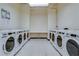 Clean and spacious laundry room with multiple washing machines for tenant convenience at 20 Marietta Nw St # 15D, Atlanta, GA 30303