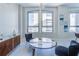 Bright sitting area features a sleek marble table set and art at 20 Marietta Nw St # 15D, Atlanta, GA 30303