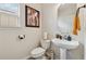 Small bathroom with white pedestal sink, modern fixtures, and framed art at 2229 Polder Way, Austell, GA 30168