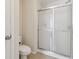 Bathroom featuring a tiled walk-in shower with a glass enclosure and modern fixtures at 2229 Polder Way, Austell, GA 30168