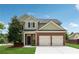 Charming two-story home with a brick facade and manicured front lawn and two-car garage at 2229 Polder Way, Austell, GA 30168