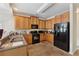 Functional kitchen with wooden cabinets, black appliances, and tile flooring at 2229 Polder Way, Austell, GA 30168