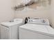 Functional laundry area with a washer, dryer, and overhead storage shelf at 2229 Polder Way, Austell, GA 30168
