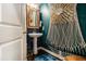 Stylish powder room with a pedestal sink and a decorative sunburst mirror at 2404 Fitts Dr, Conyers, GA 30094