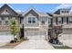 Charming townhome featuring a two-car garage and a beautifully landscaped front yard at 2404 Fitts Dr, Conyers, GA 30094