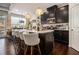Modern kitchen with sleek black cabinets, a center island, and hardwood floors at 2404 Fitts Dr, Conyers, GA 30094